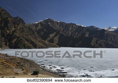"Frozen mountain lake of Tian Chi, with the Peak of God, 5445m, Bogeda Feng, Heaven Lake, Tian Chi, Tian Shan, Tien Shan, Urumqi, Xinjiang, China, Asia" View Large Photo Image Picture - "Frozen mountain lake of Tian Chi, with the Peak of God, 5445m, Bogeda Feng, Heaven Lake, Tian Chi, Tian Shan, Tien Shan, Urumqi, Xinjiang, China, Asia". Fotosearch