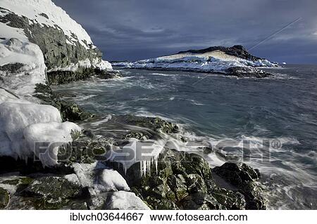 Stock Photo - "Frozen rocks, coast, Antarctic Peninsula, Antarctica". Fotosearch