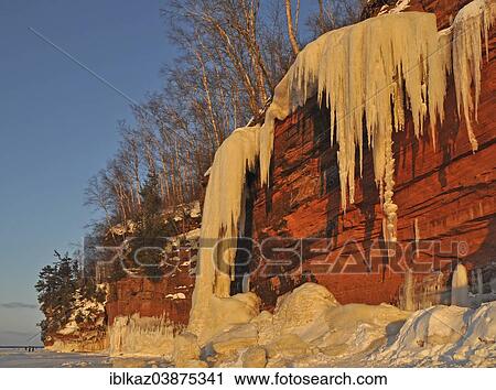 "Frozen waterfall and icicles hanging from red sandstone cliff, Lakes Superior, Apostle Islands National Lakeshore, Bayfield, Wisconsin, USA" View Large Photo Image Stock Image - "Frozen waterfall and icicles hanging from red sandstone cliff, Lakes Superior, Apostle Islands National Lakeshore, Bayfield, Wisconsin, USA". Fotosearch
