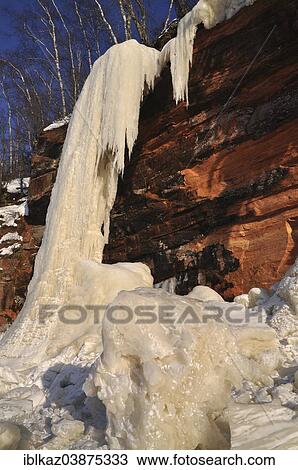 "Frozen waterfall, chunks of ice and icicles hanging from red sandstone cliff, Apostle Islands National Lakeshore, Lake Superior, Bayfield, Wisconsin, USA" View Large Photo Image Stock Image - "Frozen waterfall, chunks of ice and icicles hanging from red sandstone cliff, Apostle Islands National Lakeshore, Lake Superior, Bayfield, Wisconsin, USA". Fotosearch