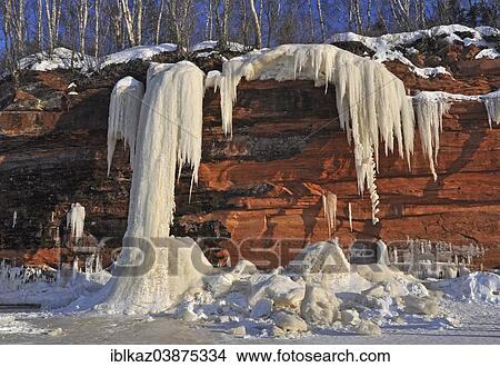 "Frozen waterfall, ice chunks and icicles hanging from red sandstone cliff, Apostle Islands National Lakeshore, Lake Superior, Bayfield, Wisconsin, USA" View Large Photo Image Picture - "Frozen waterfall, ice chunks and icicles hanging from red sandstone cliff, Apostle Islands National Lakeshore, Lake Superior, Bayfield, Wisconsin, USA". Fotosearch