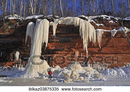 "Frozen waterfall, ice chunks and icicles hanging from red sandstone cliff, Apostle Islands National Lakeshore, Lake Superior, Bayfield, Wisconsin, USA" View Large Photo Image Stock Photography - "Frozen waterfall, ice chunks and icicles hanging from red sandstone cliff, Apostle Islands National Lakeshore, Lake Superior, Bayfield, Wisconsin, USA". Fotosearch