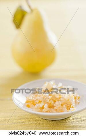 Stock Image - Fruit jam made from pears with a fresh pear in the back. Fotosearch