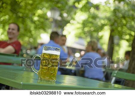 "Full beer mug on a table in a beer garden, Englischer Garten, Munich, Upper Bavaria, Bavaria, Germany, Europe" View Large Photo Image Stock Image - "Full beer mug on a table in a beer garden, Englischer Garten, Munich, Upper Bavaria, Bavaria, Germany, Europe". Fotosearch