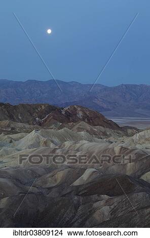 "Full moon over the Panamint Range and the Death Valley at dawn, seen from Zabriskie Point, the badlands of Gower Gulch in the foreground, Death Valley National Park, California, USA" View Large Photo Image Picture - "Full moon over the Panamint Range and the Death Valley at dawn, seen from Zabriskie Point, the badlands of Gower Gulch in the foreground, Death Valley National Park, California, USA". Fotosearch