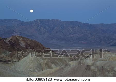 "Full moon over the Panamint Range and the Death Valley at dawn, seen from Zabriskie Point, the badlands of Gower Gulch in the foreground, Death Valley National Park, California, USA" View Large Photo Image Stock Image - "Full moon over the Panamint Range and the Death Valley at dawn, seen from Zabriskie Point, the badlands of Gower Gulch in the foreground, Death Valley National Park, California, USA". Fotosearch
