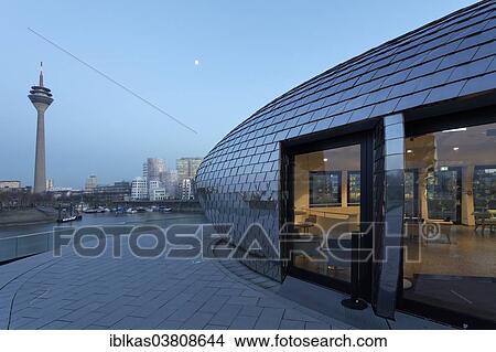 "Futuristic pavilion with a mirrored facade, Hyatt Regency hotel bar """"Pebble's"""" at the blue hour, Media Harbour, Dusseldorf, North Rhine-Westphalia, Germany, Europe" View Large Photo Image Picture - "Futuristic pavilion with a mirrored facade, Hyatt Regency hotel bar """"Pebble's"""" at the blue hour, Media Harbour, Dusseldorf, North Rhine-Westphalia, Germany, Europe". Fotosearch