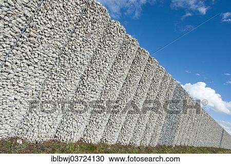 "Gabion wall, mesh baskets filled with stones, noise protection wall on the Autobahn A9 motorway, Bavaria, Germany, Europe" View Large Photo Image Stock Image - "Gabion wall, mesh baskets filled with stones, noise protection wall on the Autobahn A9 motorway, Bavaria, Germany, Europe". Fotosearch
