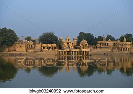 "Gadi Sagar, water supply lake with pavilions and temple complexes on the banks, Jaisalmer, Rajasthan, India, Asia" View Large Photo Image Stock Image - "Gadi Sagar, water supply lake with pavilions and temple complexes on the banks, Jaisalmer, Rajasthan, India, Asia". Fotosearch