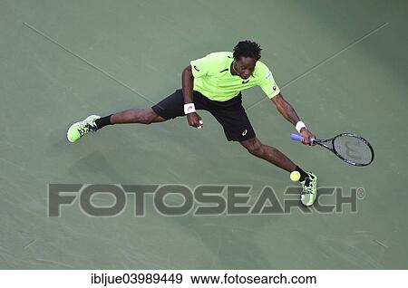 Stock Photo - "Gael Monfils, FRA, switching the hand, US Open 2014, ITF Grand Slam Tennis Tournament, USTA Billie Jean King National Tennis Center, Flushing Meadows, New York, United States, North America". Fotosearch