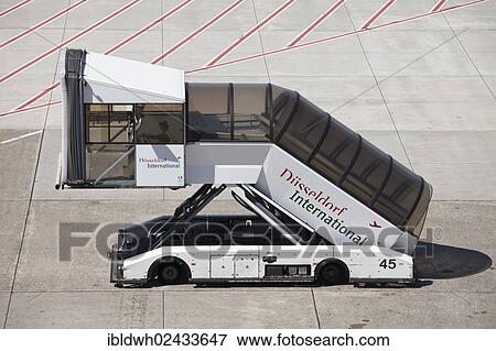 "Gangway vehicle on the manoeuvring area, Duesseldorf International Airport, Duesseldorf, North Rhine-Westphalia, Germany, Europe" View Large Photo Image Stock Photo - "Gangway vehicle on the manoeuvring area, Duesseldorf International Airport, Duesseldorf, North Rhine-Westphalia, Germany, Europe". Fotosearch