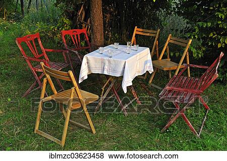 "Garden table with glasses and chairs in the evening light, Eckental, Middle Franconia, Bavaria, Germany, Europe" View Large Photo Image Stock Photo - "Garden table with glasses and chairs in the evening light, Eckental, Middle Franconia, Bavaria, Germany, Europe". Fotosearch