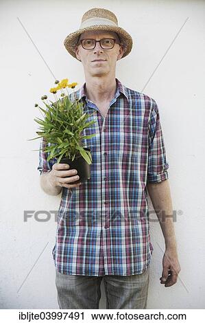 "Gardener, garden plot holder, holding a flower in his hand, Germany, Europe" View Large Photo Image Stock Image - "Gardener, garden plot holder, holding a flower in his hand, Germany, Europe". Fotosearch