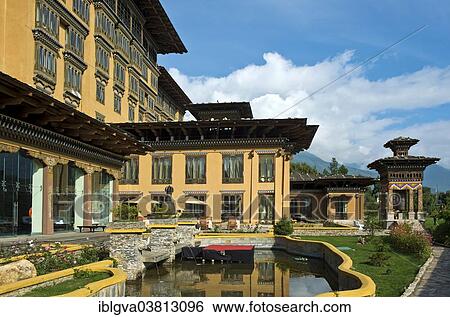 Stock Photograph - "Gardens with a prayer wheel at the Taj Tashi Hotel, Thimphu, Bhutan, Asia". Fotosearch