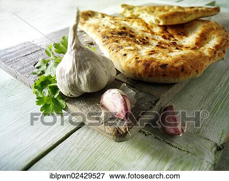Garlic and coriander Indian Naan bread View Large Photo Image Stock Photo - Garlic and coriander Indian Naan bread. Fotosearch