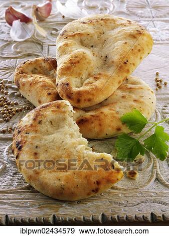 Garlic and coriander Indian naan bread View Large Photo Image Stock Photo - Garlic and coriander Indian naan bread. Fotosearch