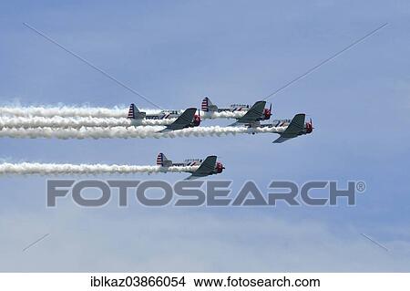 "Geico Skytypers T-6 Aerobatic Team performs at Milwaukee Air Show, Milwaukee, Wisconsin, USA" View Large Photo Image Picture - "Geico Skytypers T-6 Aerobatic Team performs at Milwaukee Air Show, Milwaukee, Wisconsin, USA". Fotosearch