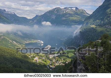 "Geirangerfjord with cruise ships, view from the lookout point of Flydalsjuvet towards mountains at the rear, Geiranger, Geirangerfjord, More og Romsdal, Western Norway, Norway, Europe" View Large Photo Image Stock Image - "Geirangerfjord with cruise ships, view from the lookout point of Flydalsjuvet towards mountains at the rear, Geiranger, Geirangerfjord, More og Romsdal, Western Norway, Norway, Europe". Fotosearch