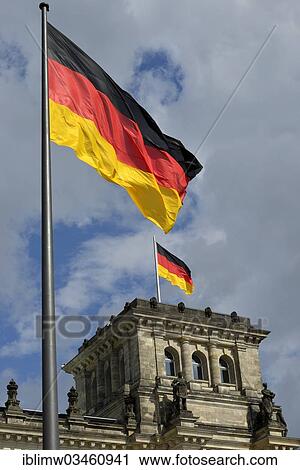 Stock Image - "German flags flying on the Reichstag Building, Bundestag, parliament, Government District, Berlin, Berlin, Germany, Europe". Fotosearch