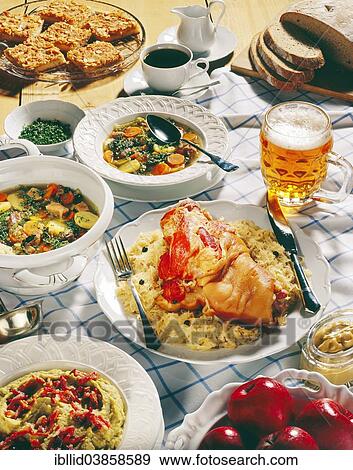 "German national cuisine, Pichelsteiner stew, pork knuckle with sauerkraut, mashed peas, beer, German buttercake, coffee" View Large Photo Image Stock Photo - "German national cuisine, Pichelsteiner stew, pork knuckle with sauerkraut, mashed peas, beer, German buttercake, coffee". Fotosearch