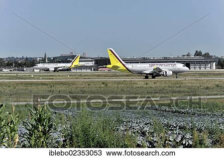 Stock Image - "Germanwings D-AKNP Airbus A319-112 landing at Stuttgart Airport, with Germanwings D-AKNN Airbus A319-112 which has already landed at the rear, Stuttgart, Baden-Wuerttemberg, Germany, Europe". Fotosearch
