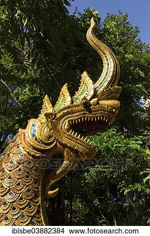 Picture - "Gilded Naga figure at the entrance of Wat Phra Kaeo, Wat Phra Kaew, Chiang Rai, Chiang Rai province, Northern Thailand, Thailand, Asia". Fotosearch