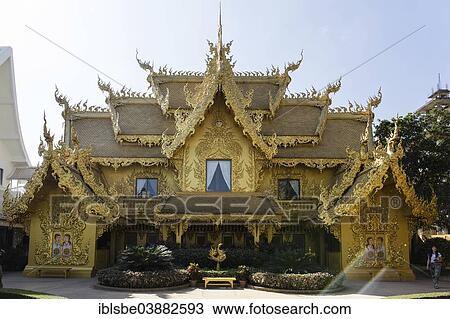 Stock Image - "Gilded toilet house at Wat Rong Khun, White Temple, by architect Chalermchai Kositpipat, Chiang Rai, Chiang Rai Province, Northern Thailand, Thailand, Asia". Fotosearch