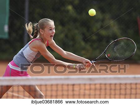 "Girl, 11, playing tennis, hitting a backhand volley, Munich, Upper Bavaria, Bavaria, Germany, Europe" View Large Photo Image Stock Photograph - "Girl, 11, playing tennis, hitting a backhand volley, Munich, Upper Bavaria, Bavaria, Germany, Europe". Fotosearch