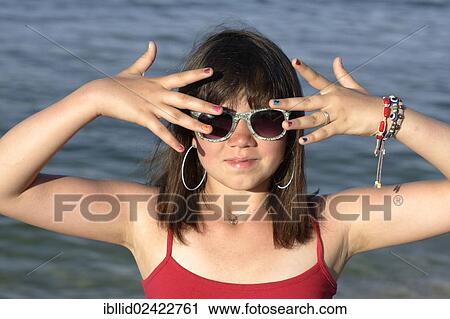 Girl, 12, wearing sunglasses and showing her colourful painted fingernails View Large Photo Image Stock Image - Girl, 12, wearing sunglasses and showing her colourful painted fingernails. Fotosearch