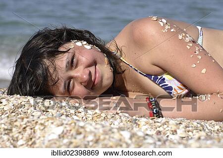 "Girl, 12 years old, lying on the beach" View Large Photo Image Stock Photo - "Girl, 12 years old, lying on the beach". Fotosearch