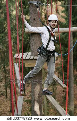 Stock Photograph - "Girl, 13 years, in the climbing park, Svaty Linhart, Karlovy Vary, Region Karlovy Vary, Bohemia, Czech Republic, Europe". Fotosearch