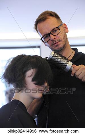 Girl, 14, at the hairdresser, having a blow dry with a round brush View Large Photo Image Stock Photograph - Girl, 14, at the hairdresser, having a blow dry with a round brush. Fotosearch