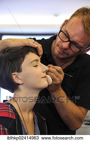 Stock Image - Girl, 14, at the hairdresser, having make-up applied, eyeliner. Fotosearch