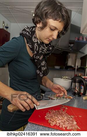 Girl, 14 years old, cutting ham in a kitchen with a knife View Large Photo Image Stock Image - Girl, 14 years old, cutting ham in a kitchen with a knife. Fotosearch