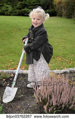 "Girl, 2 years, with a spade in the garden, Ystad, Scania, Sweden, Europe" View Large Photo Image Stock Photo - "Girl, 2 years, with a spade in the garden, Ystad, Scania, Sweden, Europe". Fotosearch
