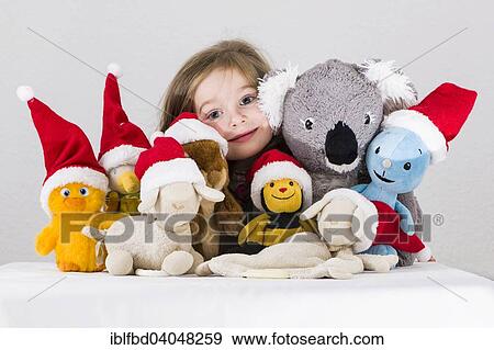 "Girl, 3 years, with plush toys wearing Santa Claus hats" View Large Photo Image Stock Photo - "Girl, 3 years, with plush toys wearing Santa Claus hats". Fotosearch