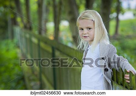 "Girl, 4 years old, leaning against a wooden fence" View Large Photo Image Stock Image - "Girl, 4 years old, leaning against a wooden fence". Fotosearch