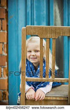 "Girl, 4 years old, looking through a chair's backrest" View Large Photo Image Stock Photo - "Girl, 4 years old, looking through a chair's backrest". Fotosearch