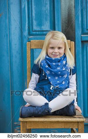 "Girl, 4 years old, sitting in front of a blue door" View Large Photo Image Stock Image - "Girl, 4 years old, sitting in front of a blue door". Fotosearch