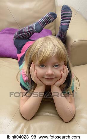 "Girl, 5 years, lying on the sofa" View Large Photo Image Stock Photo - "Girl, 5 years, lying on the sofa". Fotosearch