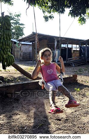 "Girl, 6, swinging on a swing attached to a tree branch, San Gregorio, Caaguazu Department, Paraguay, South America" View Large Photo Image Stock Photography - "Girl, 6, swinging on a swing attached to a tree branch, San Gregorio, Caaguazu Department, Paraguay, South America". Fotosearch