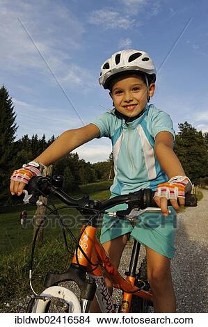Girl, 7, riding a mountain bike View Large Photo Image Picture - Girl, 7, riding a mountain bike. Fotosearch