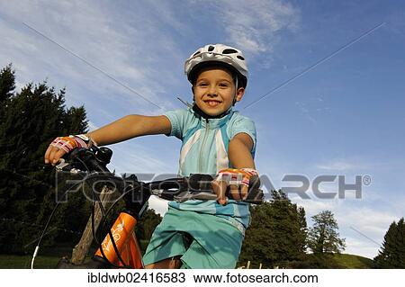 Girl, 7, riding a mountain bike View Large Photo Image Stock Image - Girl, 7, riding a mountain bike. Fotosearch