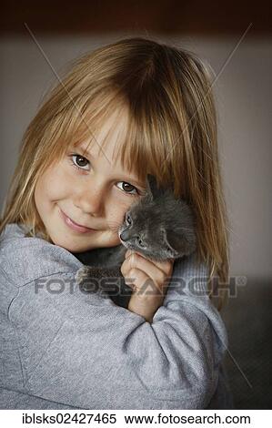 "Girl, 7 years, cuddling a kitten, portrait" View Large Photo Image Stock Photography - "Girl, 7 years, cuddling a kitten, portrait". Fotosearch