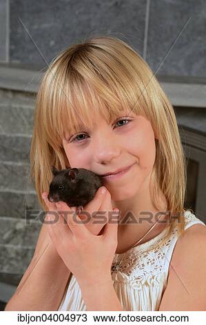 "Girl, 8 years, holding a hamster next to her face, Sweden, Europe" View Large Photo Image Stock Image - "Girl, 8 years, holding a hamster next to her face, Sweden, Europe". Fotosearch