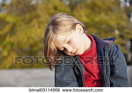 Stock Photo - "Girl, 8 years, thoughtful, Esslingen, Baden-Wurttemberg, Germany, Europe". Fotosearch