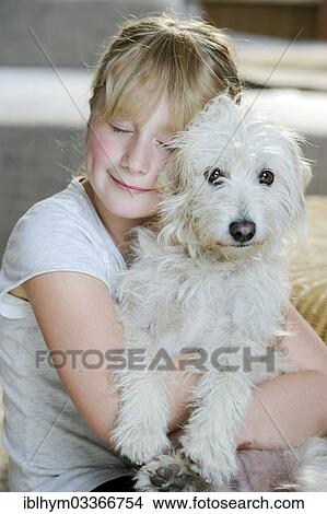 "Girl, 9, cuddling with a young mixed-breed dog" View Large Photo Image Picture - "Girl, 9, cuddling with a young mixed-breed dog". Fotosearch