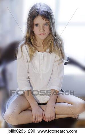 "Girl, 9, sitting cross-legged" View Large Photo Image Stock Image - "Girl, 9, sitting cross-legged". Fotosearch
