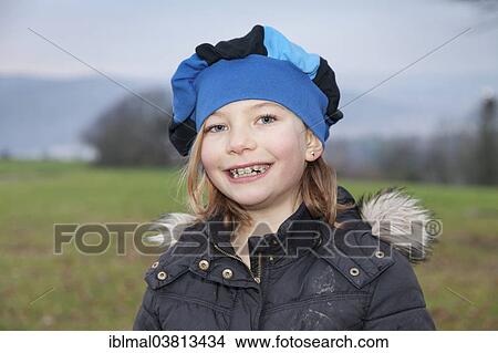 Picture - "Girl, 9, with braces, wearing a cap, portrait". Fotosearch
