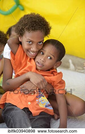 "Girl, 9 years, and boy, 6 years, embracing each other, kindergarten of a social project, slum, Mangueirinha favela, Duque de Caxias, Rio de Janeiro, Brazil, South America" View Large Photo Image Stock Photo - "Girl, 9 years, and boy, 6 years, embracing each other, kindergarten of a social project, slum, Mangueirinha favela, Duque de Caxias, Rio de Janeiro, Brazil, South America". Fotosearch